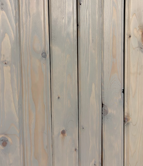 A series of wood boards stained a light grayish color.