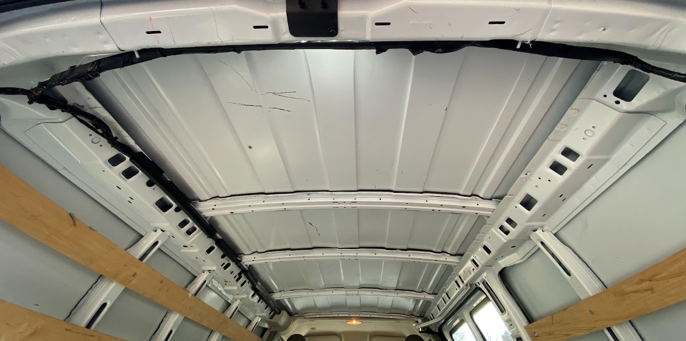 A picture of the inside of a cargo van roof, taken looking up from the rear doors.